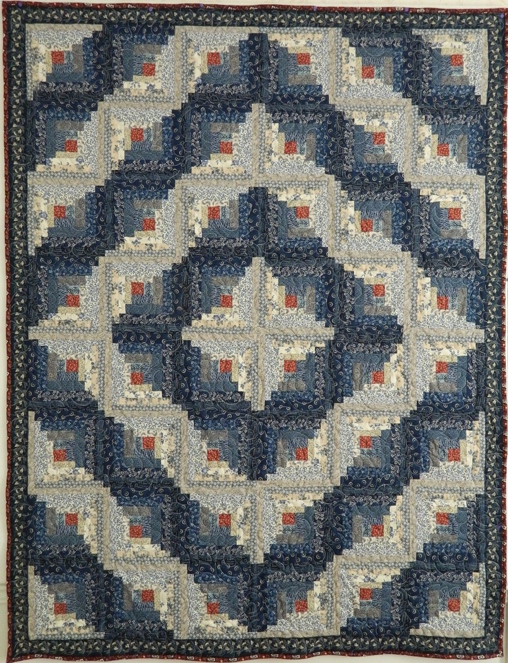 a blue and red quilt on display