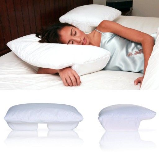 a woman laying on top of a bed next to pillows and pillow protectors for sleeping