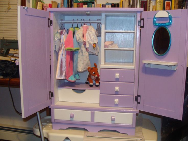 a doll's closet with clothes and toys in it