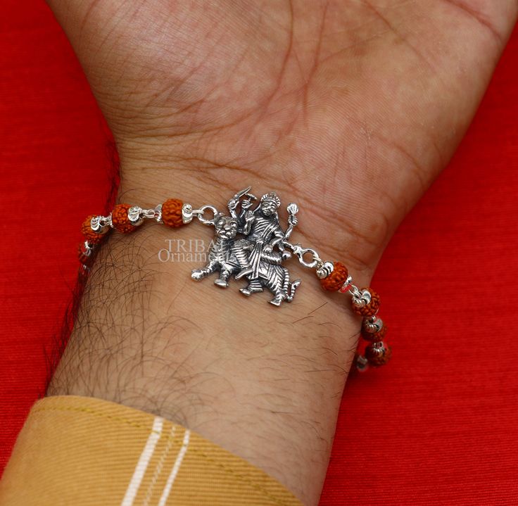 This amazing silver Rakhi crafted from 925 silver with immense precision. It exudes excellent craftsmanship and will surely look wonderful on your brother's wrist. handmade custom design Goddess divine Bracelet Or Rakhi bracelet with silver, rudraksha and holy Basil Rosary beaded chain, this is special design beaded bracelet we can use either Rakhi bracelet or daily use bracelet for unisex. Best Rakshabandhan Festival best wishes sibling gift for your brother and sister's , Metal-925 sterling si Silver Bracelets For Navratri, Adjustable Silver Jewelry For Puja, Adjustable Silver Bracelets For Diwali, Silver Bracelet For Navratri Festival, Silver Bracelet For Navratri Festive Occasion, Silver Bracelet For Navratri Rituals, Silver Bracelets For Navratri Rituals, Festive Silver Bracelets For Navratri, Silver Bracelet Jewelry For Diwali