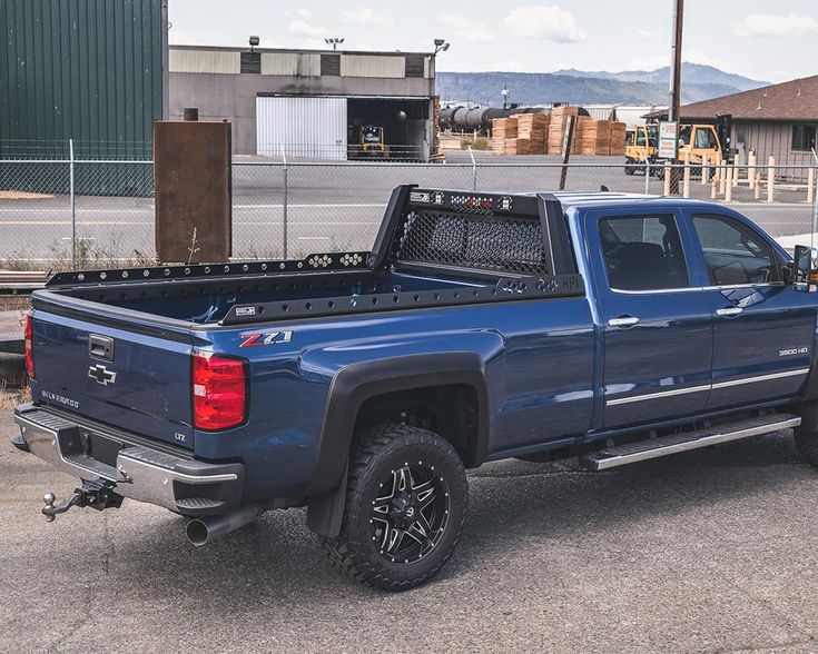 a blue pickup truck parked in a parking lot