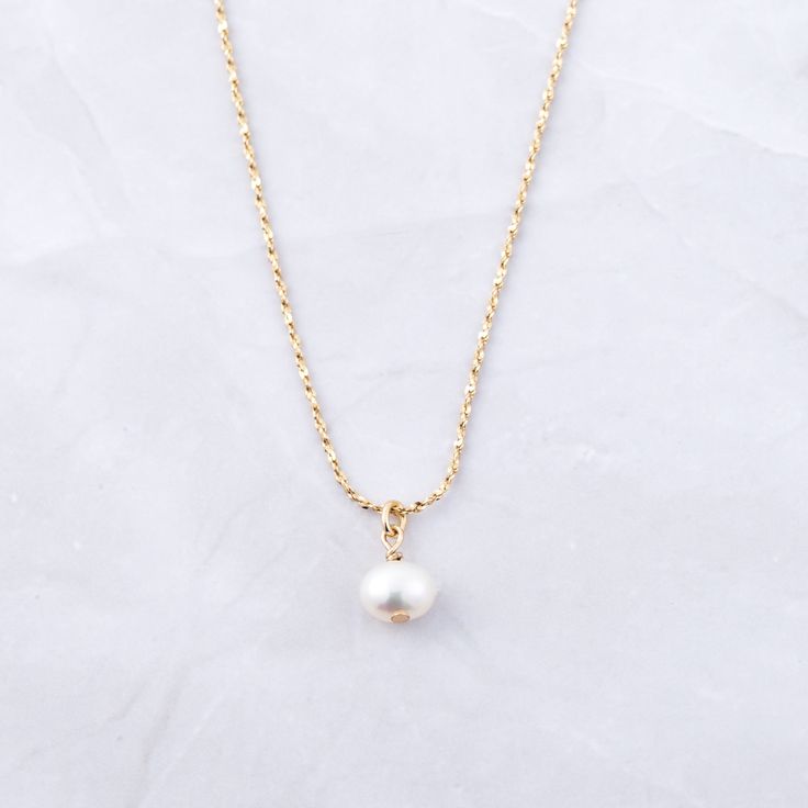 The ultimate symbol of elegance - PEARLS! They are trendy & a beautiful way to add a feminine touch to your outfit! The diamond cut design on the chain also makes the chain sparkle - adding a niced touch! Made of 925 Sterling Silver THICK plating of 14k Gold Made of Freshwater Pearls 16" + 3" Ext Chain Pendant : 6mm Nickel-free & Hypoallergenic Lobster Clasp Closure Classic Gold Jewelry With Pearl Charm, Elegant Round Charm Necklace With Cable Chain, Classic Round Jewelry With Adjustable Chain, Elegant Jewelry With Cable Chain And Round Pendant, Dainty Pearl White Jewelry With Pearl Charm, White Classic Necklace With Delicate Chain, Elegant Gold Plated Cable Chain Jewelry, Classic White Necklace With Delicate Chain, Elegant Gold-plated Jewelry With Cable Chain