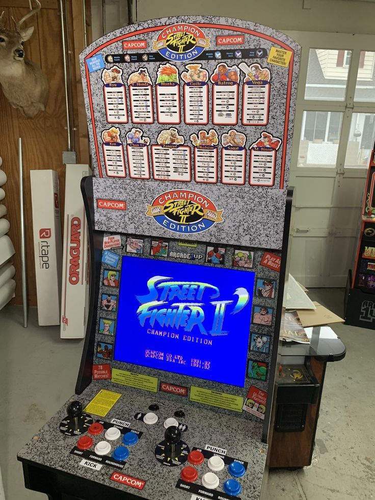 an old school arcade machine in a room with other items on the wall and around it