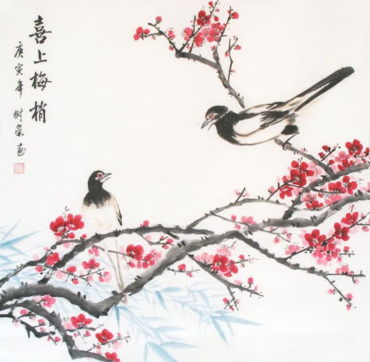 two birds sitting on a branch with red flowers in the foreground and chinese writing below