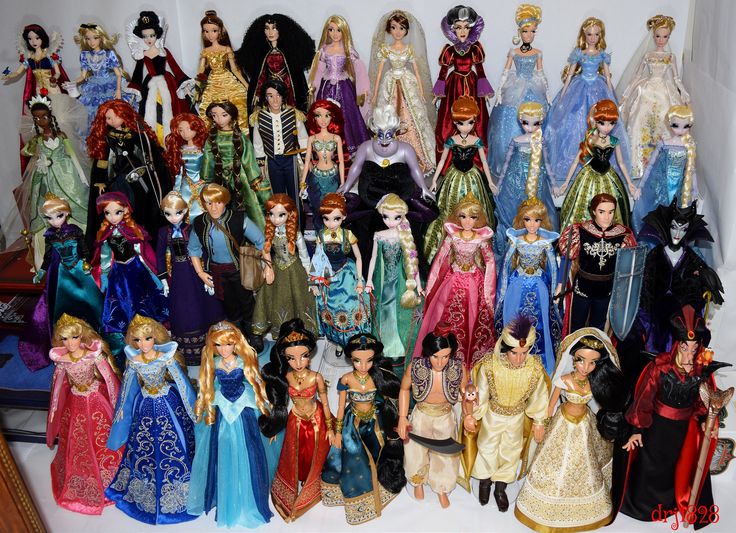 a group of dolls that are all dressed in different colors and sizes, standing next to each other