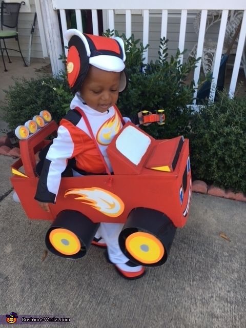 a little boy in a fire truck costume