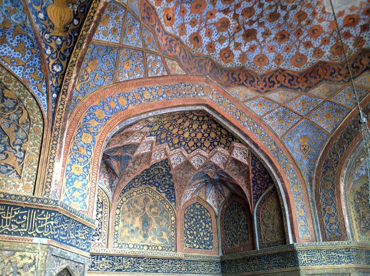 the interior of an ornate building with blue and gold paint on it's walls