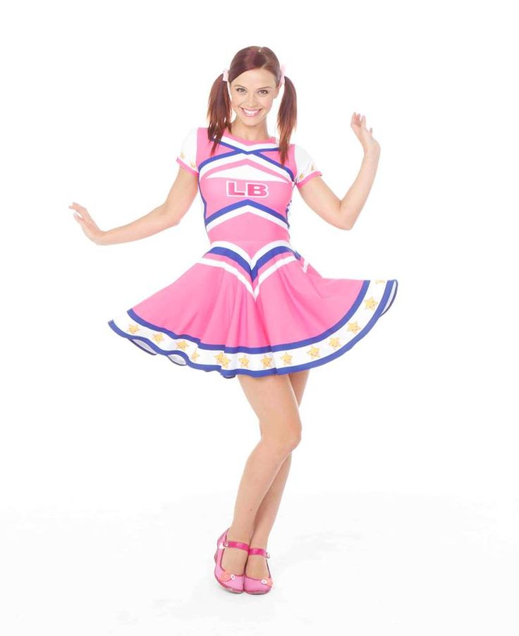 a woman in a pink and blue cheerleader costume posing for the camera with her arms out