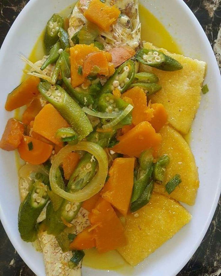 a white bowl filled with food on top of a table