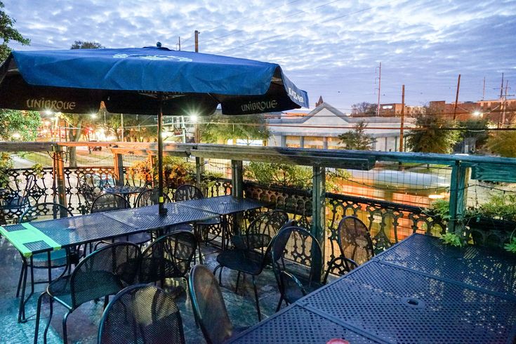 an outdoor dining area with tables and umbrellas