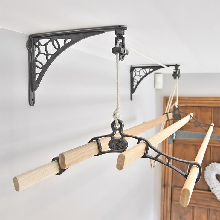 an iron and wood chandelier hangs from the ceiling