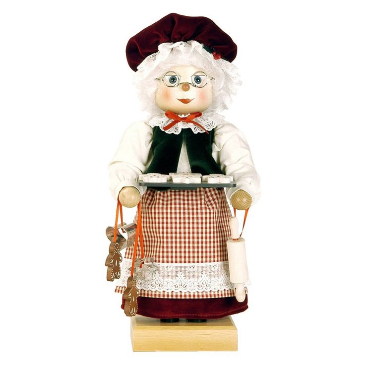 a figurine of a woman with an apron and hat holding a plate in her hands