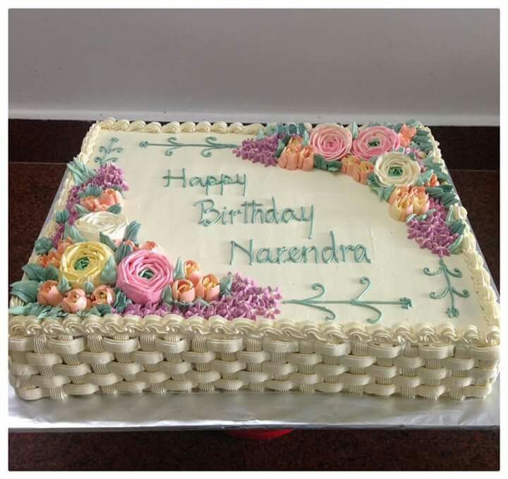 a birthday cake with white frosting and flowers on it