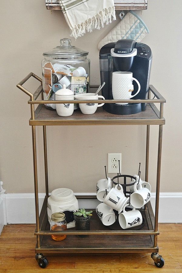 a coffee bar cart with cups and mugs on it