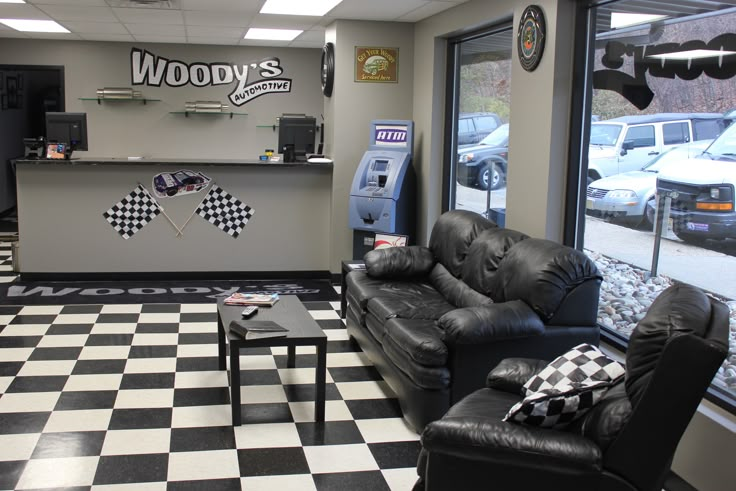 a checkered floor with two couches in front of a cash register and vending machine