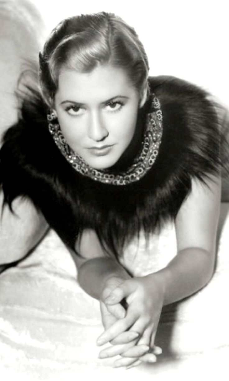 black and white photograph of a woman laying on a bed