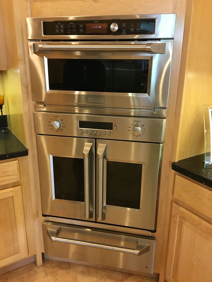 a stainless steel oven and microwave in a kitchen