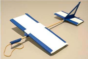 a blue and white glider sitting on top of a brown floor next to a power cord