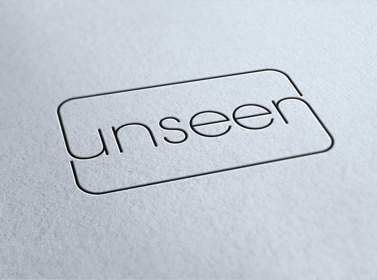 an unseen logo is shown on a piece of paper with the word unseen in black ink