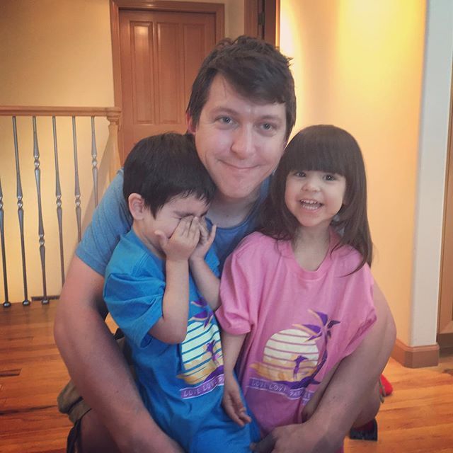 a man and two children posing for a photo