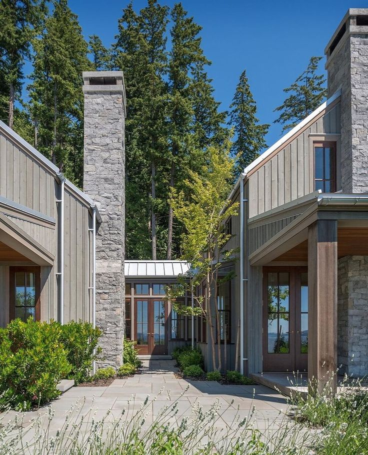 an exterior view of a house with stone pillars