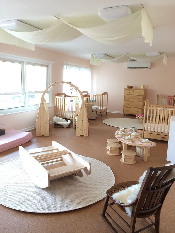 a baby's room with cribs, rocking chairs and other furniture in it