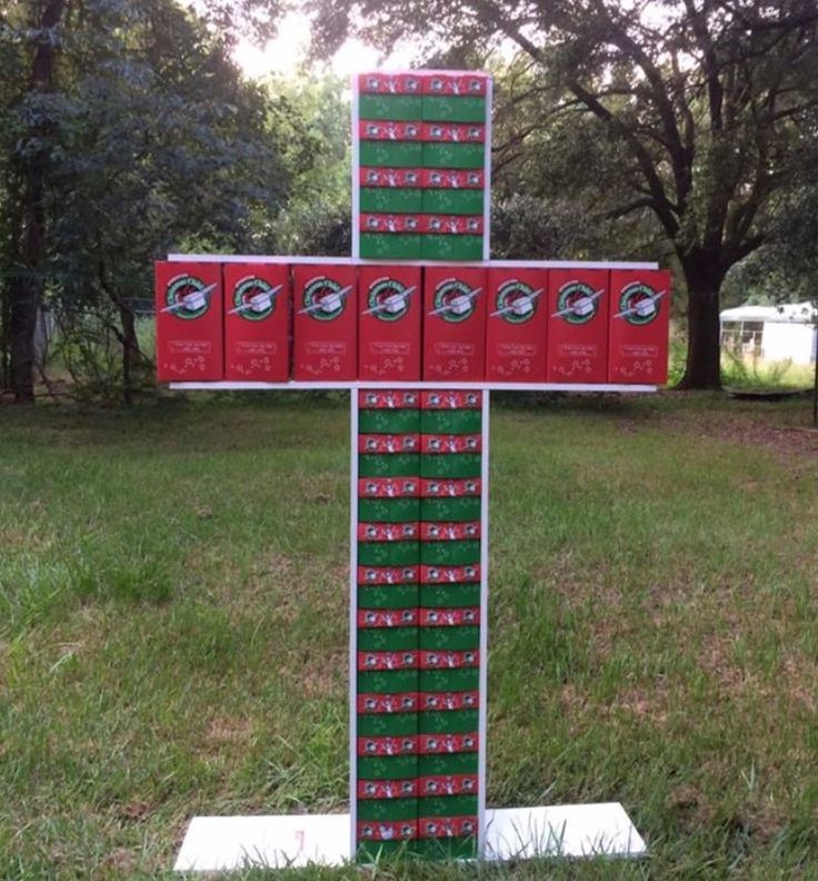 a cross made out of boxes in the grass