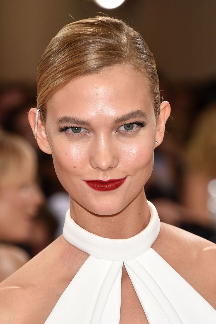 a woman with red lipstick and white dress