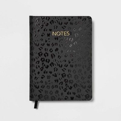 a notebook with the words notes written in gold foil on top of black leopard print