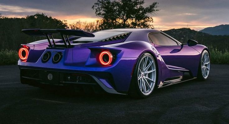 a purple sports car parked on the road