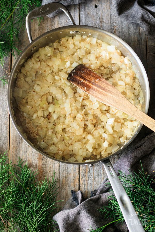 a pot filled with onions on top of a wooden table