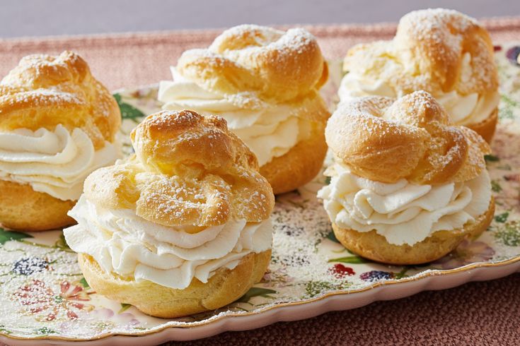 several pastries on a plate with frosting and sprinkles in them