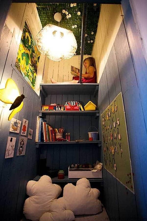 there is a small room with bookshelves and pictures on the wall above it