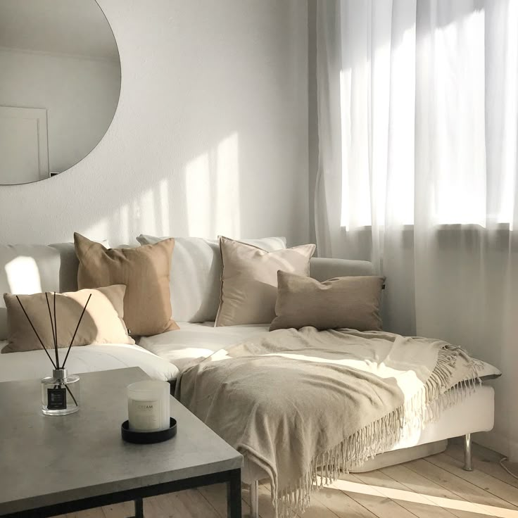 a living room with a couch, table and mirror