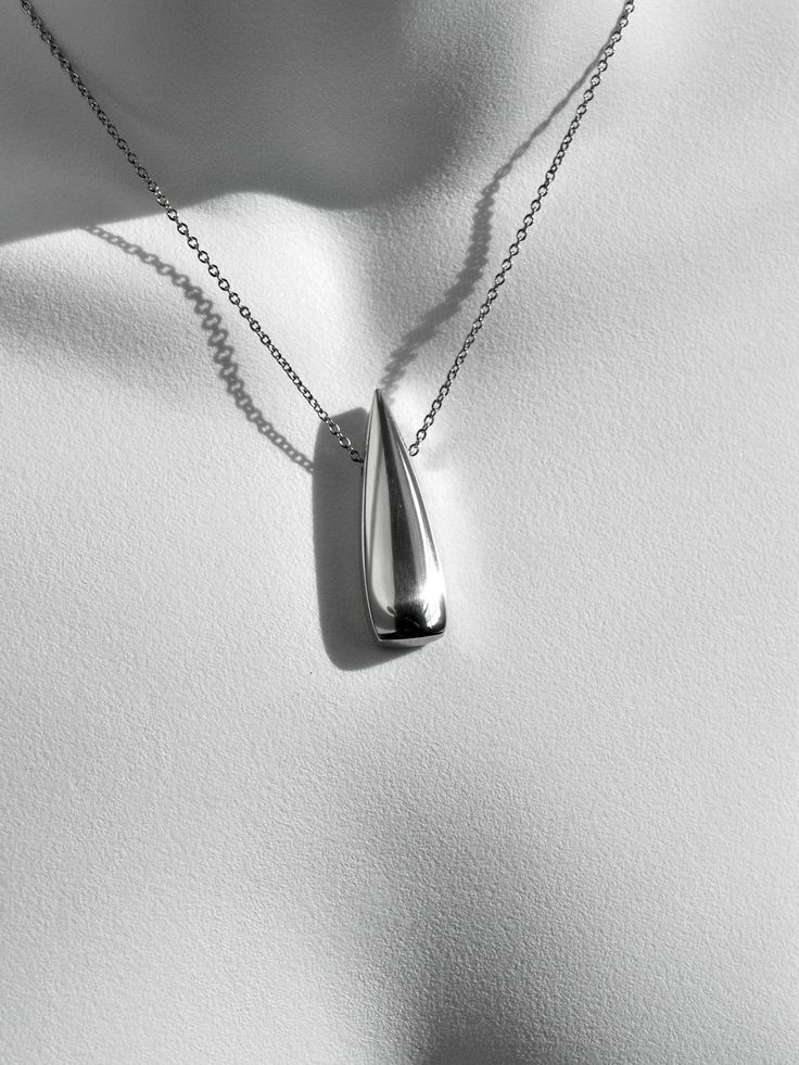 No.307 Anniversary Flame  I am the creator of this bold, modern-contemporary 10 Year Anniversary Flame necklace. Sculpted from aerospace grade aluminum alloy, it will not tarnish or discolor and is lightweight. It has been sculpted completely by hand and finished by hand to a mirrored luster. FREE PERSONALIZATION: (OPTIONAL)  If you would like to personalize your necklace, please enter a date in the box above. See diagram slide above for engraving format. Limit 15 characters including periods an Modern Sterling Silver Necklaces With Shiny Finish, Modern Silver Necklace For Formal Occasions, Modern Polished Finish Necklaces For Anniversary, Modern Teardrop Necklace For Anniversary, Modern Teardrop Pendant Necklace For Anniversary, Formal Drop Necklace With Polished Finish, Modern Teardrop Pendant Necklace, Modern Silver Drop Necklaces, Formal Stainless Steel Necklace With Polished Finish