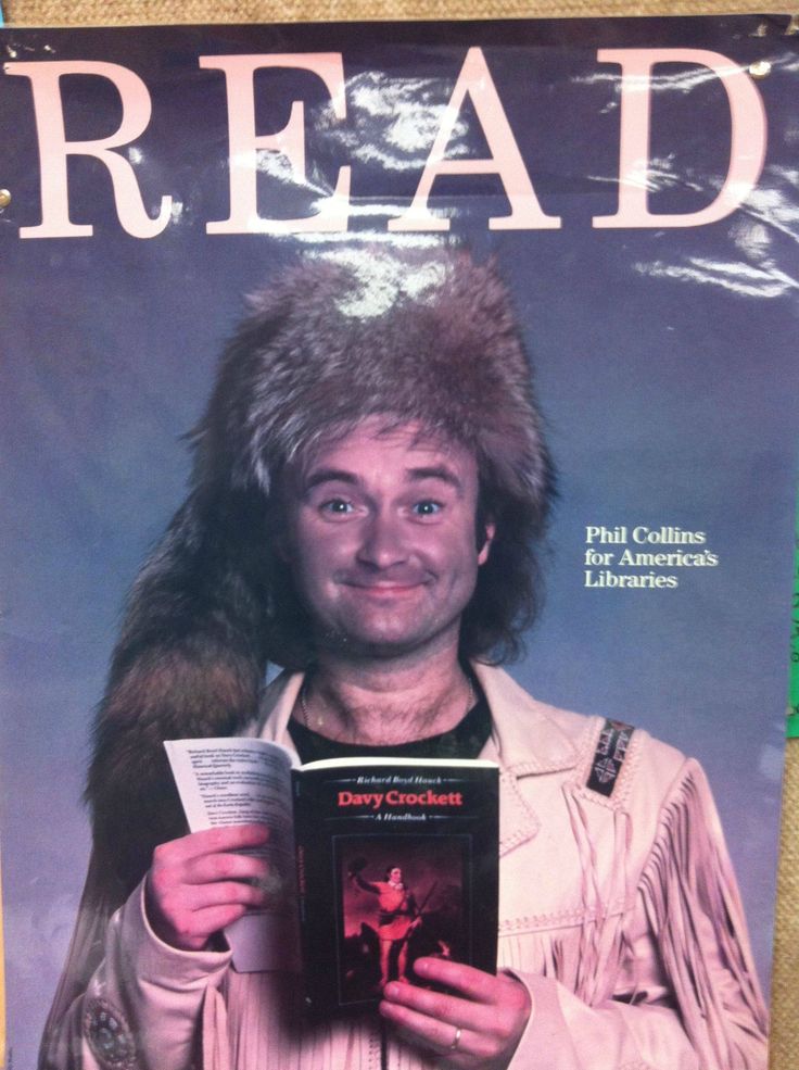 a man wearing a fur hat and holding a book in front of his face with the words read on it