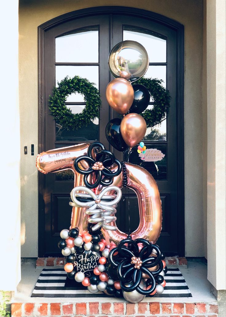 a large number balloon sculpture in front of a door