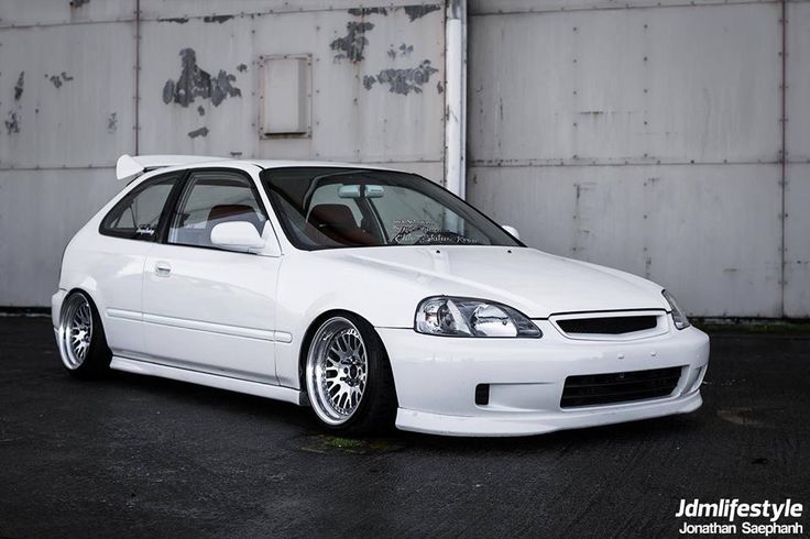 a white car parked in front of a building