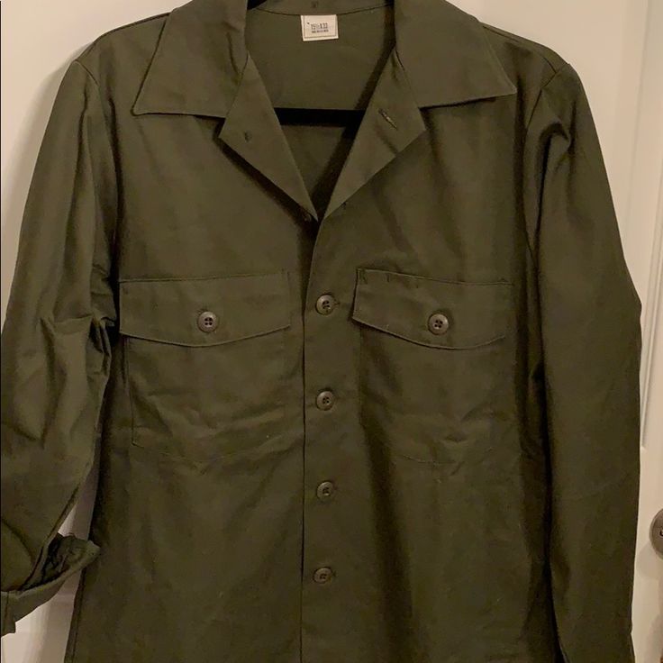 Lots Of Possibilities With This Shirt, Some Gold Bling, Wide Belt At Waist, Heavy Duty Denim Material In A Dark Olive Green. Button Up Front With Deep Pockets Both Sides. Nwot Pit To Pit Measuring 22” Length Is 29” Sleeves 25”. Looks Like A Women’s Cut Khaki Snap Buttons Button-up Shirt, Khaki Shirt With Button Closure And Lapel Collar, Military Collared Tops For Spring, Military Style Collared Tops For Spring, Spring Military Style Collared Tops, Military Style Button-up Tops With Snap Buttons, Military Style Button-up Tops, Military Style Collared Top With Snap Buttons, Khaki Collared Shirt With Snap Buttons