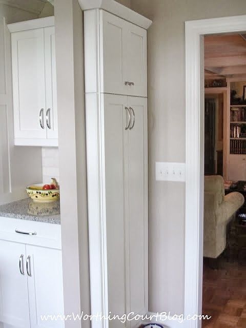 a kitchen with white cabinets and granite counter tops in the middle of an open doorway