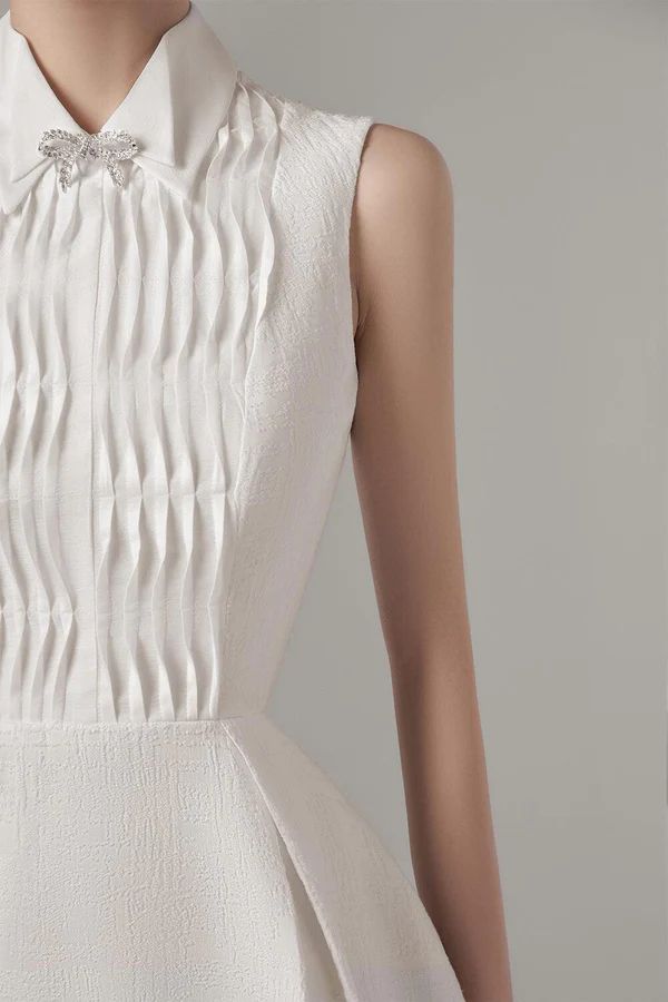 Poliana Sleeveless Dress | MEAN BLVD Classic Pleated Wedding Dress, Elegant Pleated Wedding Dress, Elegant A-line Formal Dresses, Elegant White Dress With Collar, Elegant A-line Dress With Bow, Elegant Pleated Dress For Semi-formal Occasions, Elegant Pleated Semi-formal Dress, Elegant Collared Formal Dresses, Classic Semi-formal Dresses