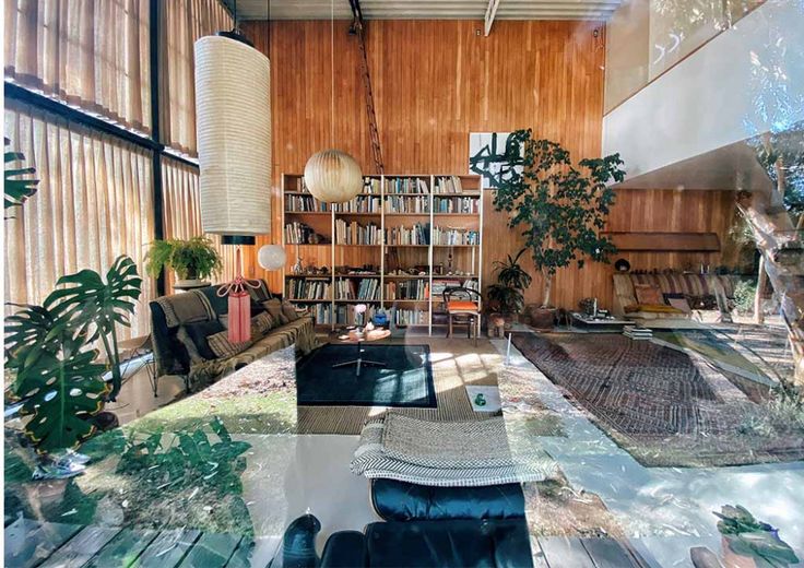 a living room filled with lots of furniture and bookshelves