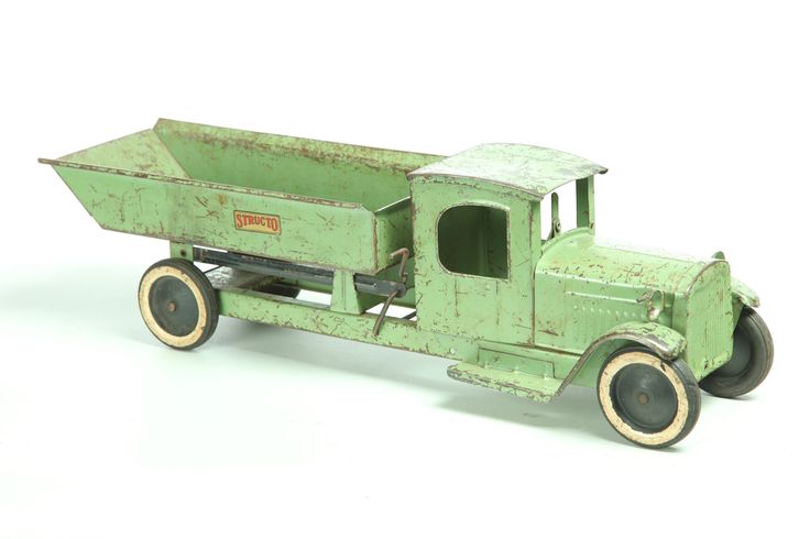 an old green toy truck on a white background