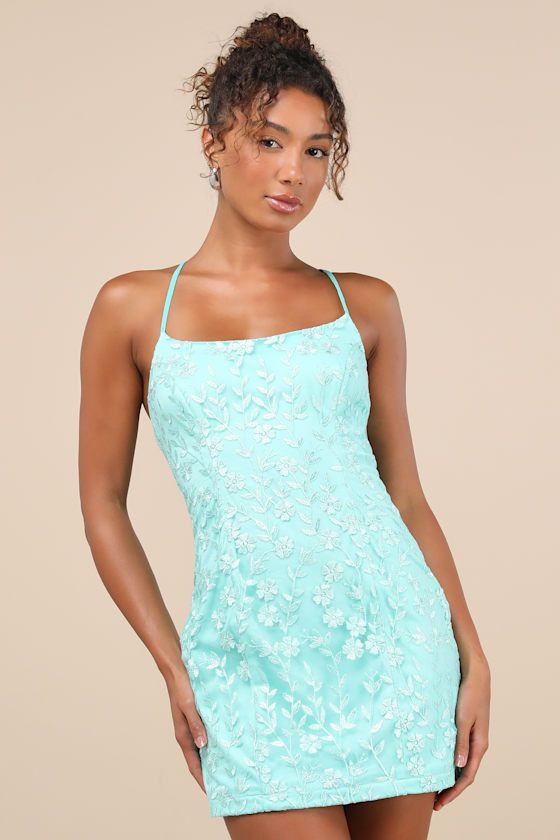 Your flirtiest heels have been begging to be paired with the Lulus Lively Sweetheart Turquoise Mesh Embroidered Lace-Up Mini Dress! Sweet floral embroidery adorns sheer mesh knit as it shapes a flattering scoop neckline supported by slender straps that lace up across the open back. The princess-seamed bodice continues into a figure-skimming bodycon silhouette that finishes with a cute mini hem. Hidden back zipper/clasp. Fit: This garment fits true to size. Length: Mid-thigh. Size medium measures Teal Hoco Dresses, Floral Homecoming Dresses, Turquoise Dress, Bodycon Floral Dress, Formal Dresses Short, Floral Embroidered Dress, Adhesive Bra, Light Teal, Sweet Floral