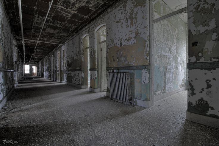 an old run down building with peeling paint on the walls and windows, along with two radiators