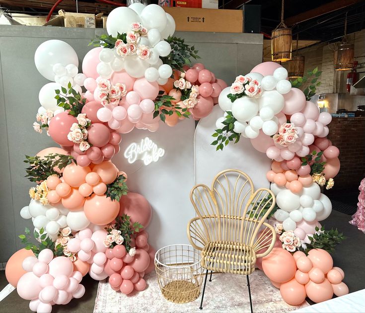 an arrangement of balloons and flowers are on display at a wedding or baby's first birthday party