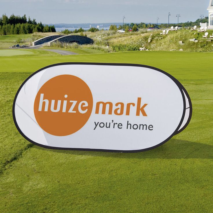 a large sign on the side of a golf course that says huze mark you're home