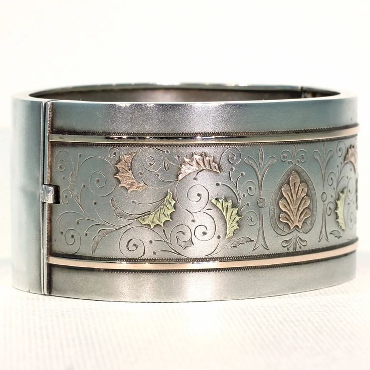 Whenever I talk about antique jewelry, I like to refer to it as 'wearable art', no where is this more clearly seen than with English Victorian silver jewelry. Each bangle, collar, earring, locket, was lovingly and elaborately made, with gold overlay, with fantastic engraving, with embossed designs, one piece more stunningly detailed than the next. This fabulous bangle was hand crafted in England around 1880. It has a lovely soft bloomed finish and is decorated with richly detailed engraving and Vintage White Gold Hallmarked Bangle, Vintage Hallmarked White Gold Bangle, Antique Cuff Bracelet With Intricate Design For Formal Occasions, Antique Round Cuff Bracelet For Wedding, Hallmarked Vintage White Gold Bangle, Formal Cuff Bracelet With Intricate Design, Vintage Bangle For Wedding, Vintage Bangle Jewelry For Wedding, Victorian Engraved Cuff Bracelet For Anniversary