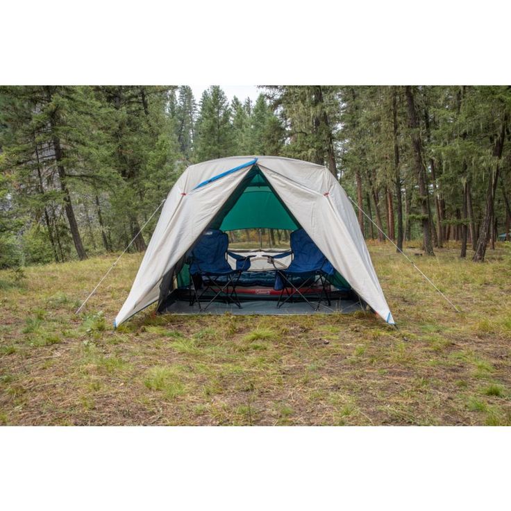 a tent pitched up in the middle of a forest