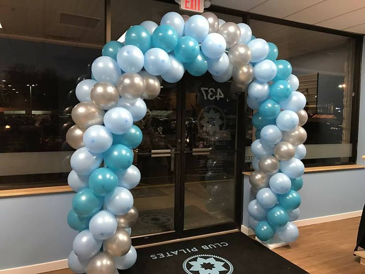 an arch made out of blue and silver balloons